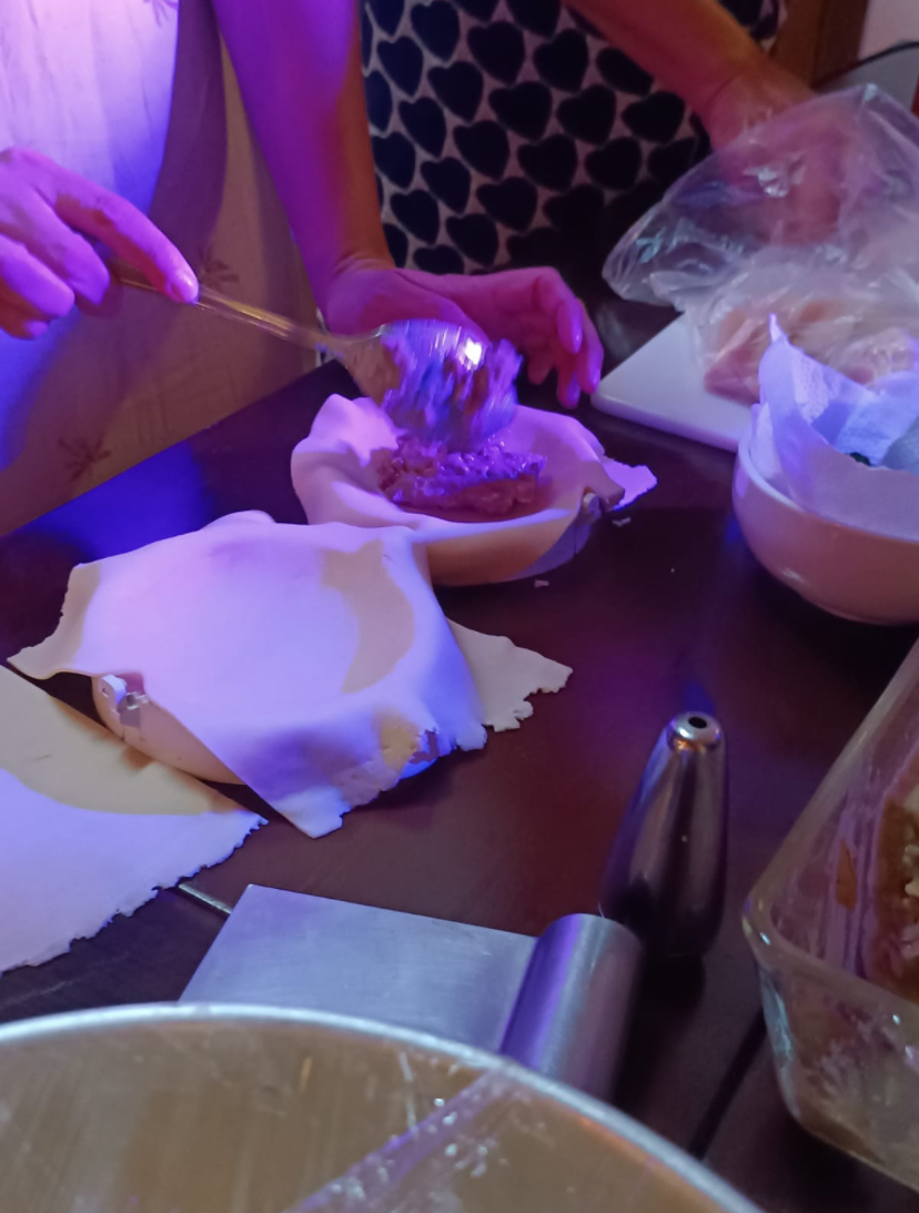 Recheio sendo colocado sobre a massa de empanada